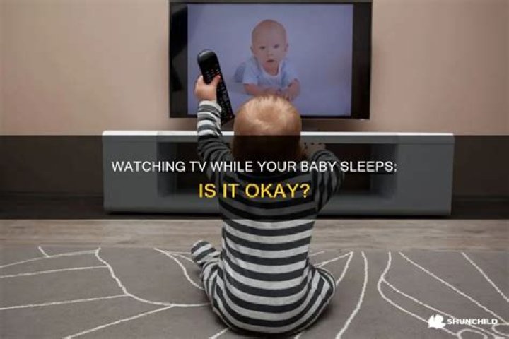 Can I watch TV while holding baby?