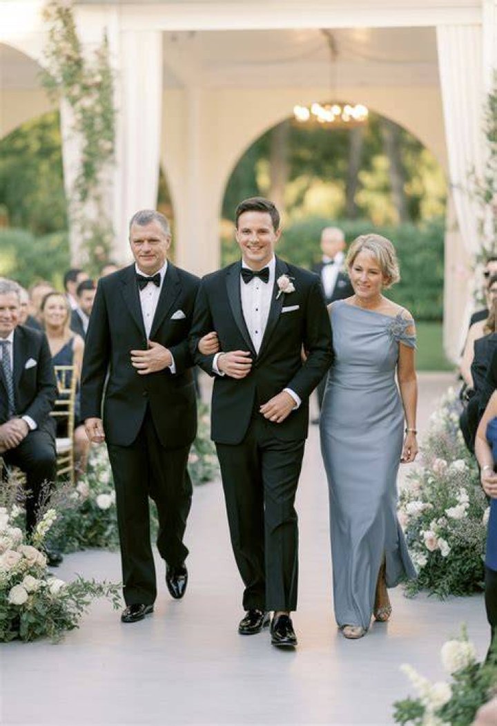 Does the groom walk down the aisle with his parents?