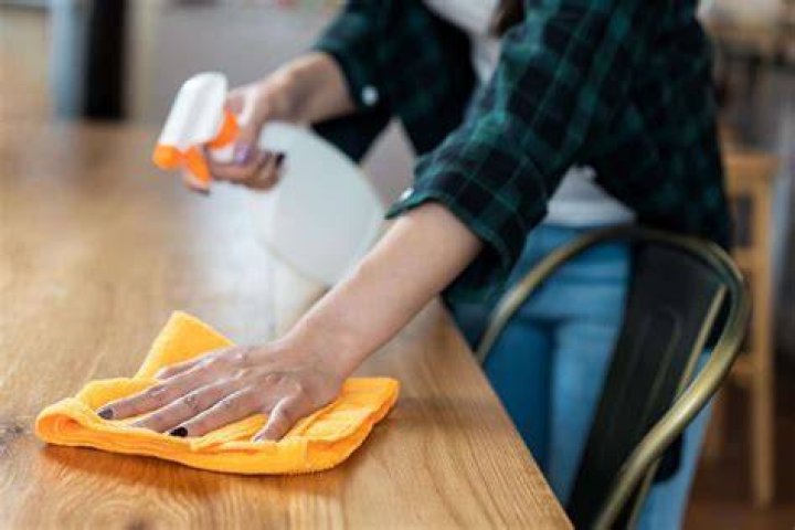 How do you clean a wooden kitchen table daily?