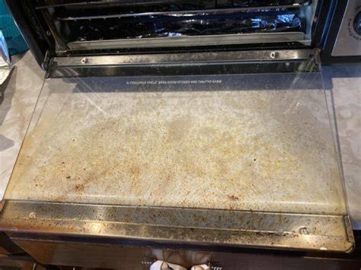 How do you get grease splatters off oven glass?