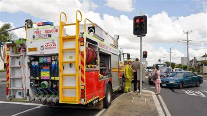 Is it legal to drive through the red light to make way for the police vehicle Qld?