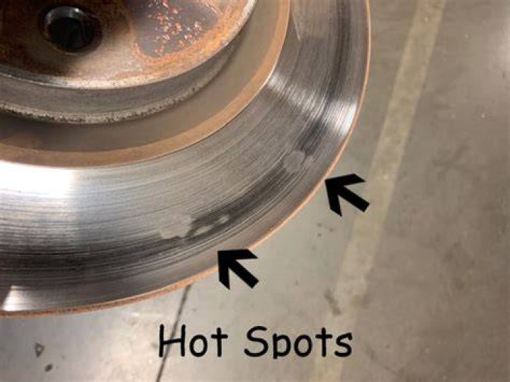 What causes hot spots on brake pads?
