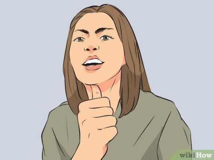 What does flicking your thumb off your teeth mean?
