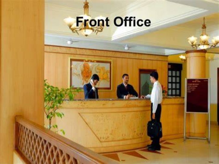 What does the Front Office department do in a hotel?