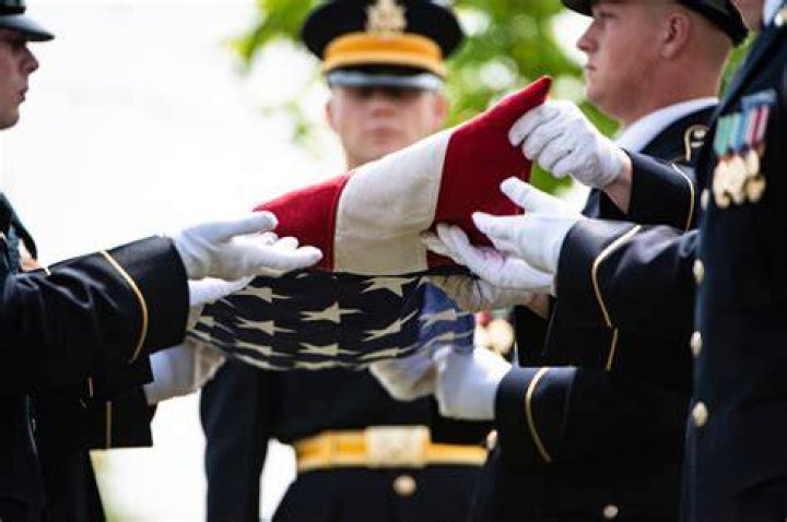 What family member gets the flag at a military funeral?