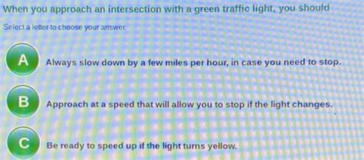 When you approach an intersection with a green traffic light you should?