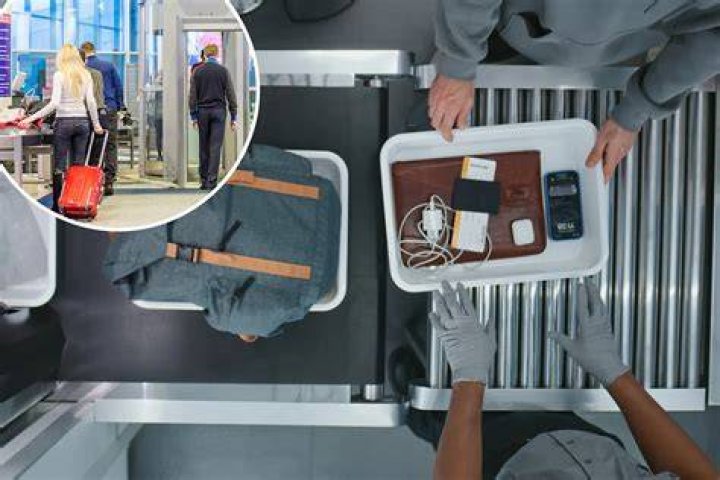 Where do you put your phone when going through TSA?