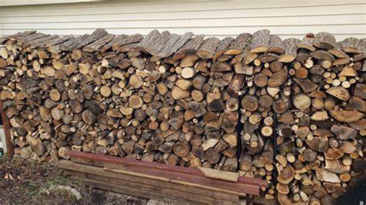 Where should firewood be stacked?