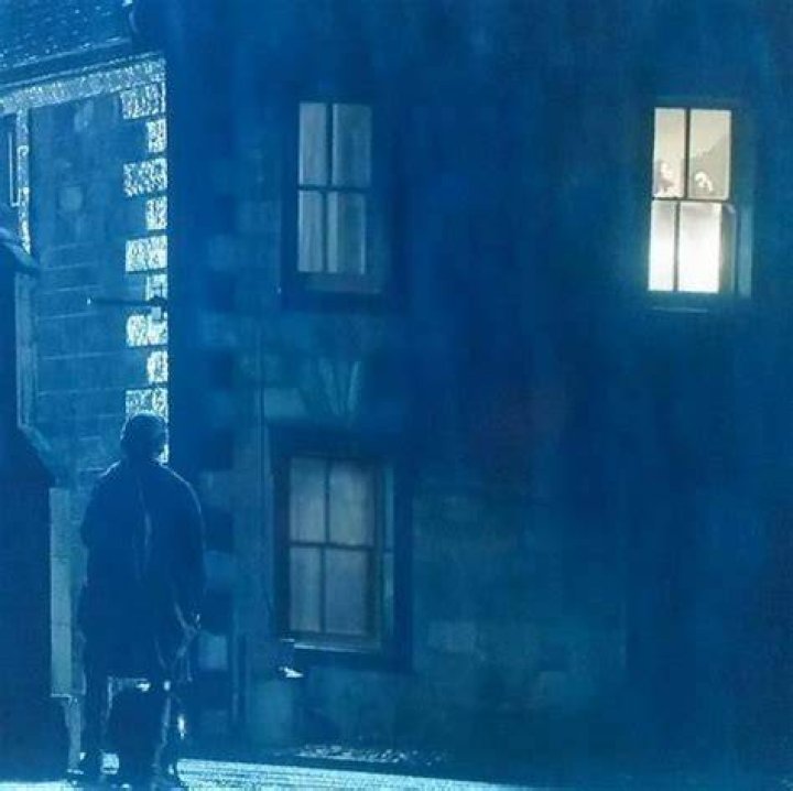 Who was the man watching Claire through the window in Outlander?