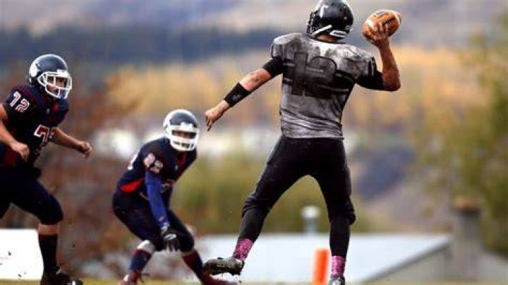 Why do quarterbacks lift their leg?