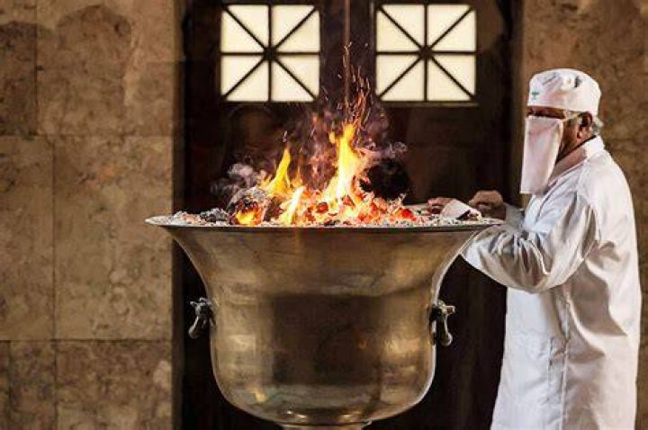 Why do Zoroastrians worship fire?